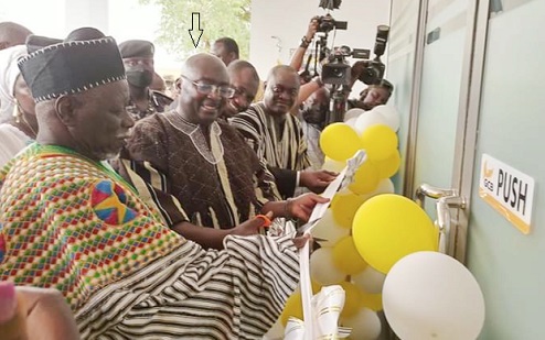 Dr Mahamudu Bawumia (arrowed) being assisted by Mba Tarana (left), Representative of the Overlord of Mamprugu, and management of the GCB Bank to inaugurate the Nalerigu branch