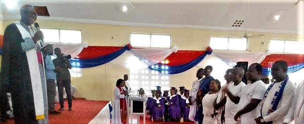 Rt Rev. Isaac Kwame Boateng (standing left) inducting the newly elected Eastern Regional NPP executive into office