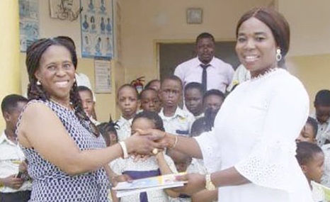 Jennifer Obeng Adom (left), Founder of Books for Kids Foundation, presenting books to Francisca Acheampong, Proprietress of Hartford Montessori
