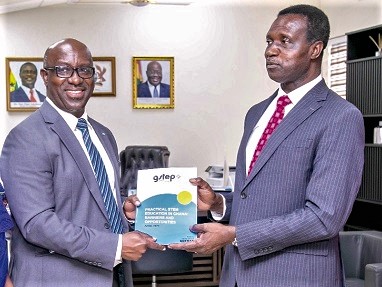 Francis Ahene-Affoh (left), Coordinator of GSTEP, presenting a copy of the report to Dr Yaw Osei Adutwum, Minister of Education