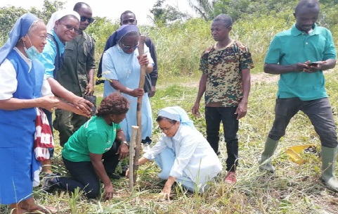 The sisters planting a seedling during the exercise