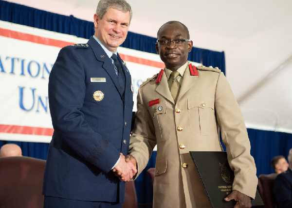 Lt Gen Michael T Plehn, President of NDU in a handshake with Col Amponsah
