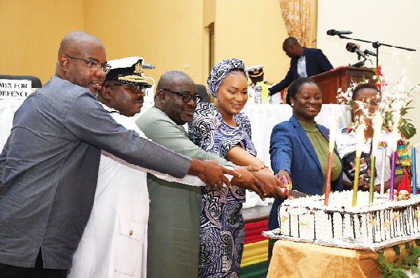 Samira Bawumia (4th from left) being assisted by Gottfred Odamtten-Sowah (left) of Mastercard Foundation, Vice-Admiral Seth Amoama, Chief of the Defence Staff; Kofi Amankwa-Manu, Deputy Minister of Defence, and Kosi Yankey-Ayeh, CEO of GEA, to cut a cake made by the trainees. 