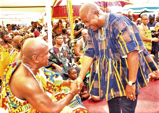 Togbe Afede (seated) and former President John Mahama in a hearty exchange of greetings at the durbar