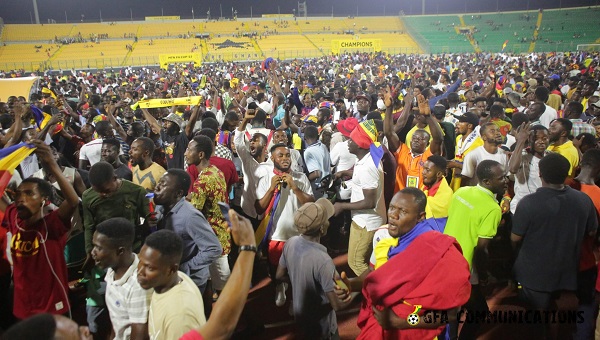 Hearts of Oak fans strom the field to celebrate their victory