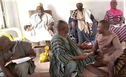 Dahima Naa (left) introducing Elyasu Yussif, the Founder of Bahass, to the elders and opinion leaders. 