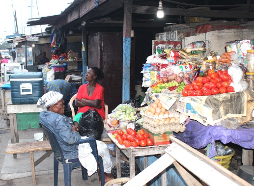 Some traders at the market, enjoy quality air outside.