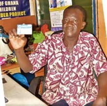 Mohammed Osman — President of Kayayei Association of Ghana, displaying a sample of the biometric card issued to some head porters in Accra.