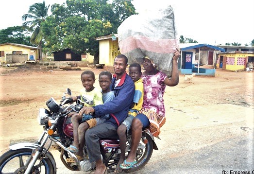 A family returning from the market on a motorbike