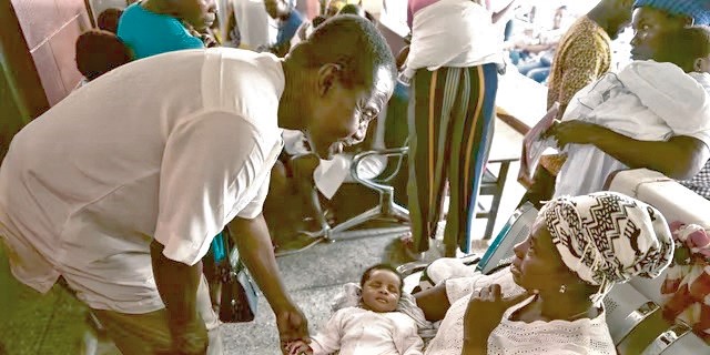 Dr Kwaku Ohen-Frempong interacting with a mother during a newborn screening exercise