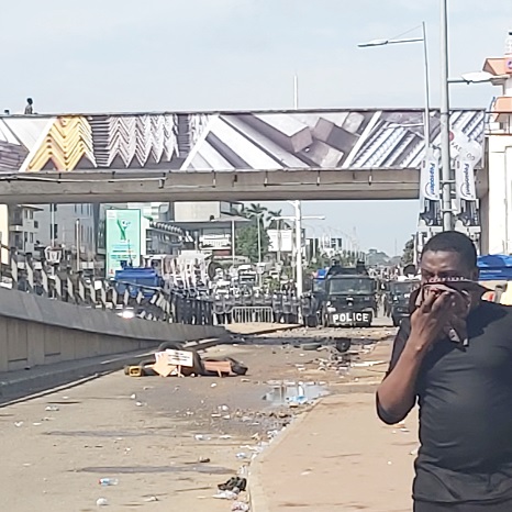 A man covering his nose after the police fired tear gas to disperse the crowd A man covering his nose after the police fired tear gas to disperse the crowd