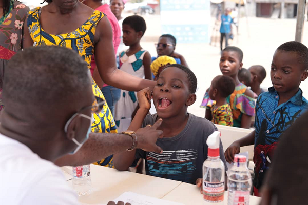 Dr Richard Esiape examining a child at the event