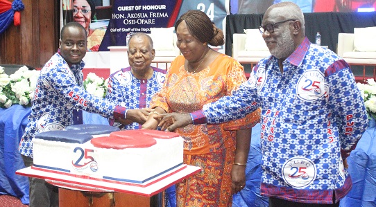 Dr Mokowa Adu Gyamfi (2nd from right) , Presidential Advisor on HIV/AIDS, Office of the President, being assisted by Nana Dr S. K. B Asante (2nd from left), legal practitioner; Dr Ishmael Ackah (left), Executive Secretary of PURC, and Ebo Quagrainie, (right) Board Chairman of PURC, to cut the anniversary cake. Picture: ERNEST KODZI