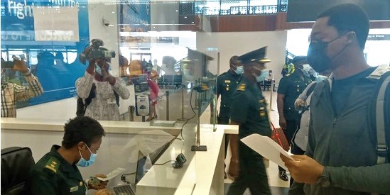 ASI Princess Delong of the Ghana Immigration Service attending to one of the passengers who was using a Ghana Card on arrival