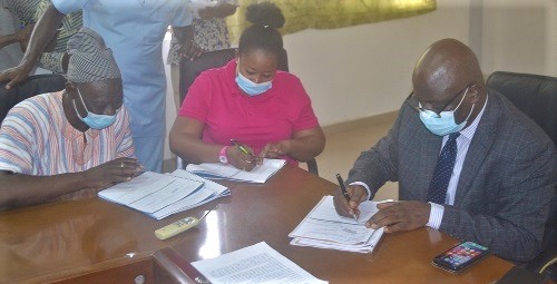 Stephen Yakubu (right), Upper East Regional Minister, together with Rita Atanga (middle), the DCE for Bongo District, signing the performance contract. Picture : GILBERT MAWULI AGBEY