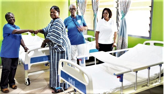 Mrs Afeti (left) handing the refurbished clinic to Madam Coffie, while two members of the POGA'72 look on