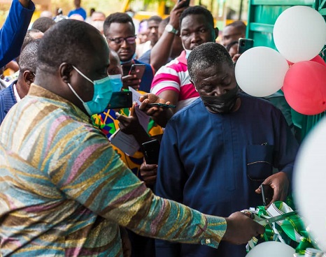 Mr. Joshua Makubu (left), Oti Regional Minister, being assisted by Mr. Benito Owusu-Bio (right), Deputy Minister of Lands and Natural Resources to cut the tape at the inauguration of the Oti Regional Lands Commission office