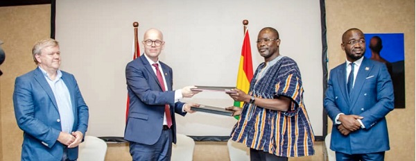 Dr Clifford Braimah (in smock) and Henrik Seiding exchanging the MoU documents. With them are Tom Nørring (left) and Richard Appiah Otoo, Chief Manager in charge of Technology and Innovation of the GWCL. Picture: DELLA RUSSEL OCLOO