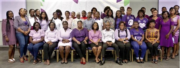 Stephen Takyi Adeakye (seated 4th from right), Head of HR at Olam Ghana, with some of the female employees after the announcement