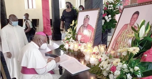 Most Rev Afrifah Agyekum, Bishop of the Koforidua Diocese of the Catholic Church, signing the book of condolence