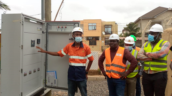 Emmanuel Amissah (left), Construction Manager at Power Factor Limited, explaining how a transformer ensures more stable power supply