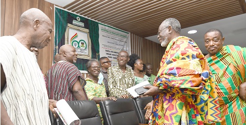 Nana Abra Appiah (right), Krontihene of Mpraeso, interacting with some members of the Old Students Association during the launch of the 60th anniversary celebrations of the school. Picture: EBOW HANSON 