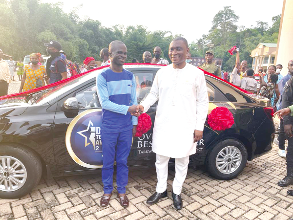   George Mireku Duker (right), MP for Tarkwa-Nsuaem, congratulating Shadrack Oteng, the Overall Best Teacher, who won a brand-new car as his prize