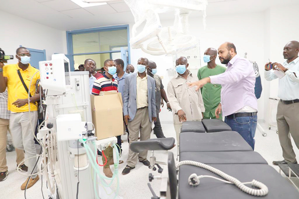  Ahmed Massaud (right), Resident Engineer, demonstrating the use of some equipment to Simon Osei Mensah, the Ashanti Regional Minister, at the Asante Akim Central Municipal Hospital