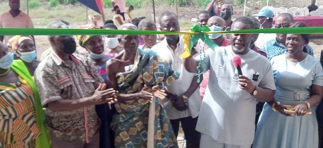 Isaac Appaw-Gyasi (2nd from right), MCE for New Juaben South, making a statement before cutting the tape to officially open the rehabilitation centre (right). Looking on are Nana Odame Affum (3rd from left), Chief of Nyamekrom, other staff of the assembly, and some residents