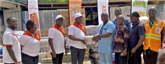 Martin Olu-Davies (4th from left) presenting the items to Dr Joseph Dasmani, while other officials look on