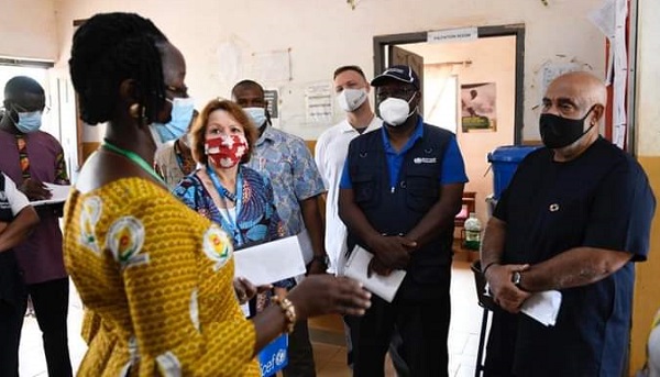 Charles Abani (right), UN Resident Coordinator to Ghana, being briefed by Joana Quarcoo (left) on the operations of the Nyankpala Health Centre