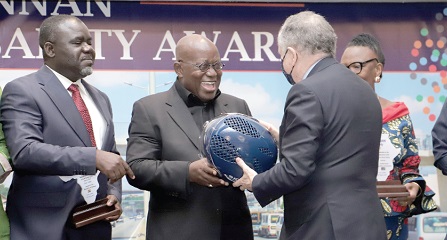 President Akufo-Addo (2nd from left) receiving a crash helmet from Mr Jean Todt (right), the UN Secretary-General's Special Envoy for Road Safety. With them is Mr Kwaku Asiamah (left), Minister of Transport
