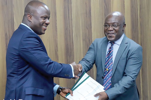 Prof. Richard Amankwah (right), Chairman of the mining industry health and safety review committee, presenting the committee's report to Samuel Abu Jinapor, Minister of Lands and Natural Resources