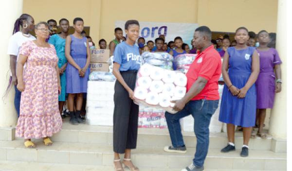 Isaac Attah (right) of the Tetteh Ocloo State School for the Blind receiving the items from a representative of Delta Paper Mill Ltd