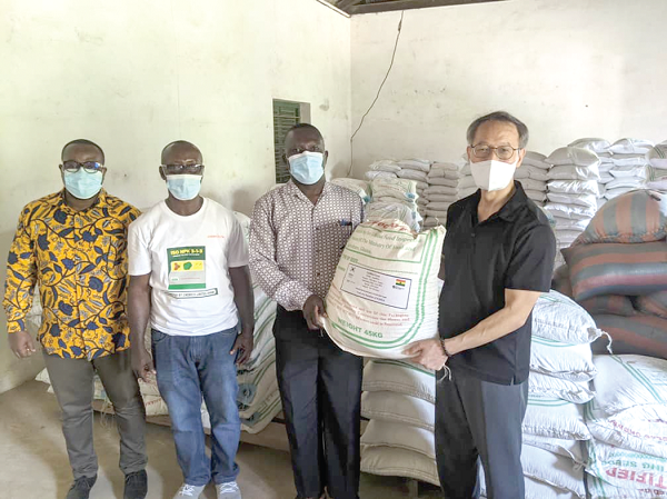 Dr Kim Sang-Yeol (right) handing over the seeds to Dr Peter Omega, the Central Regional Director of Agriculture, for onward distribution to beneficiary districts. With them are officials of the Ministry of Food and Agriculture. 