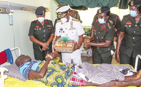  Vice-Admiral Seth Amoama, Chief of the Defence Staff, presenting items to a soldier on admission at the 37 Military Hospital. Picture: ERNEST KODZI