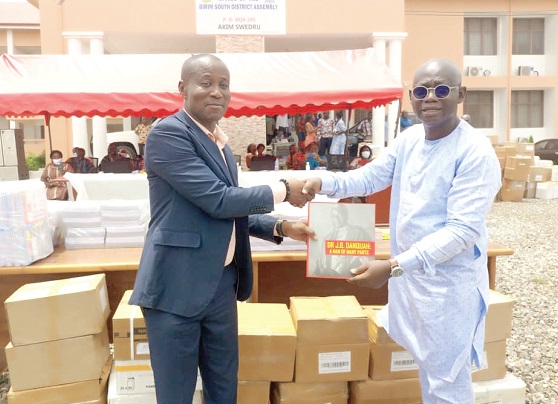  Professor Kwasi Opoku-Amankwa (right) presenting the books to Asare Danso at the function