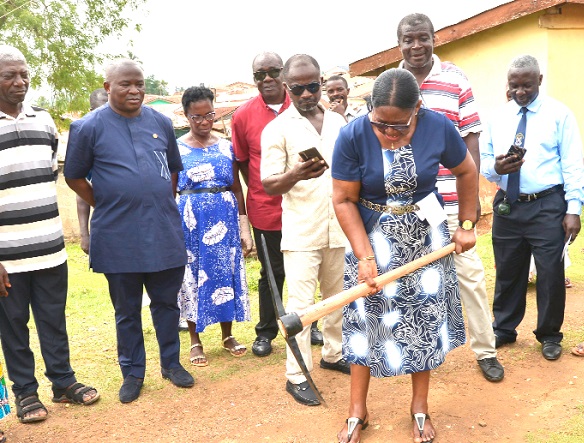 Victoria Adu, Birim Central Municipal Chief Executive, cutting the sod for the project at Oda Presbyterian cluster of schools. Among those looking on are Alexander Akwasi Acquah (2nd from left), MP for Oda.