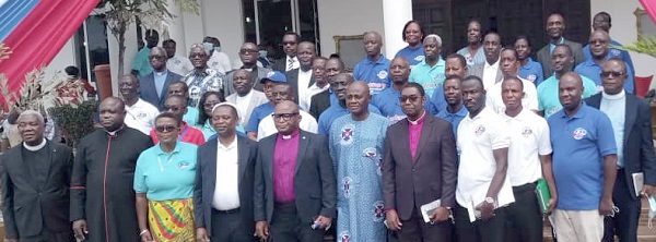 Rev. Dr Godwin Nii Noi Odonkor (5th from left), Clerk of the General Assembly of the PCG; Mr Dan Kwaku Botwe (5th from right), Minister of Local Government and Rural Development; and Rev. Dr Nana Abraham Opare Kwakye (2nd from left), Ga Presbytery Chairman of the PCG, with other leadership of the PCG. Right: The centenary anniversary cloth