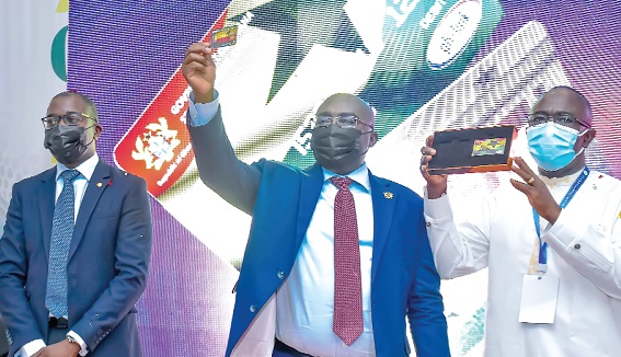 Dr Mahamudu Bawumia (middle) and Mr Kwasi Kwaning-Bosompem (right) displaying the E-Travel Card after the launch. With them is Mr Julian Opuni (left)