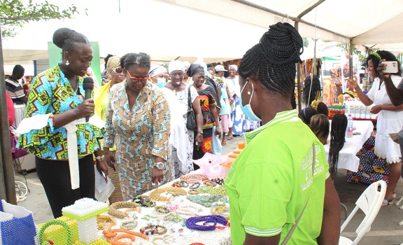 Ms Carol Annang (2nd from left), Country Director, Invest in Africa, admiring the necklace made of beads. Picture: ESTHER ADJORKOR ADJEI