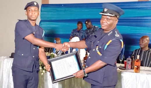  Raphael Owurani-Bediako (right) , Tamale Sector Commander, Assistant Commissioner of Customs, presenting an award to Natan Akutteh, best senior officer at the Tatale station