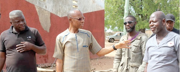 Andrews Dari Chiwitey (middle), MP for Sawla-Tuna-Kalba, in a chat with George Sobiitey Kachiir (right), Administrator of the health centre