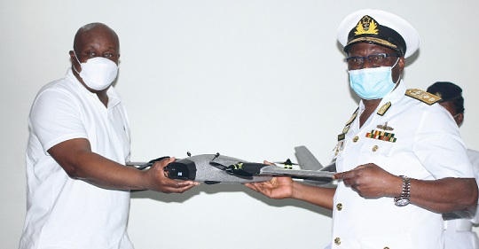 Michael Zormelo (left), Chief Executive Officer of OMNI Group of Companies Africa, presenting a drone to Rear Admiral Issah Yakubu (right), Chief of Naval Staff. PICTURE: MAXWELL OCLOO