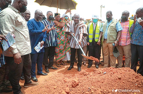 Vice-President Dr Mahamudu Bawumia (with a shovel) cuts the sod for the construction of 100 km of road network in the Ashanti Region while Mr Kwasi Amoako-Atta (3rd from right), Minister of Roads and Highways, and some dignitaries look on