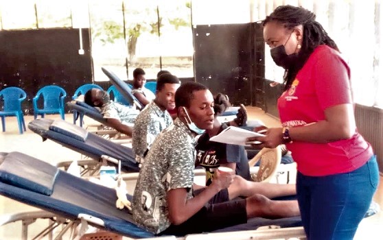 A member of the Power Queens taking the details of some students at the Accra High School