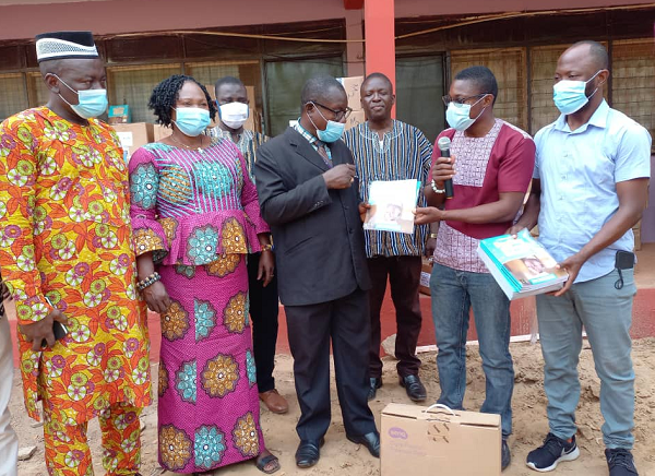 Evans Atim (second-right), Project Manager of Right To Play presenting the items to Dr Peter Attafuah (extreme left), Regional Education Directorator,looking on are some officials of the NGO and GES