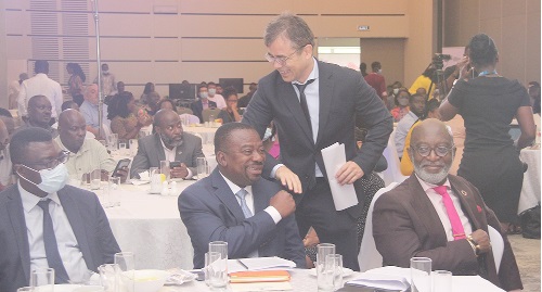 Sukhrob Khoshmukhamedov, Deputy UNDP Resident Representative in Ghana, being congratulated by Stephen Yaw Osei, Director of Policy Planning, Monitoring and Evaluation, Ministry of Works and housing. With them is Yofi Grant (seated right), Chief Executive Officer, GIPC