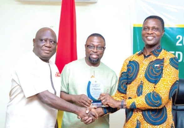 Dr Yaw Osei Adutwum (right) presenting a citation to Dr Fred Amoah Kyei, Director-General of the CTVET. Supporting Dr Adutwum to present the citation is Nana Wireko Apem-Opoku, Board Chairman of CTVET