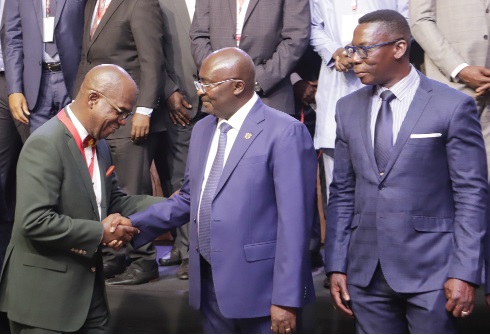 Vice-President Dr Bawumia exchanging pleasantries with  Saye Gbalazeh (left), President of WIACA. Looking on is Dr Justice Yaw Ofori (right), Commissioner of Insurance. Picture: SAMUEL TEI ADANO